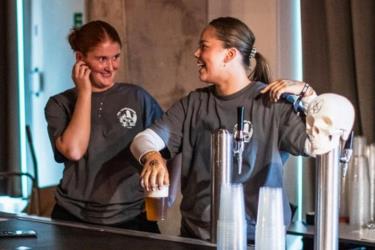 Bartenders pouring beer from tab